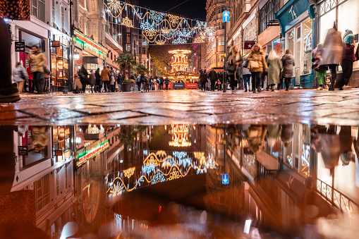 Christmas market scene with lights and people at night