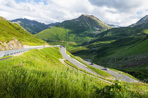 Hairpin curves on Oberalp mountain road toward Disentis in the canton of Graubunden. The Oberalp Pass is a mountain pass in the Swiss Alps that connects the cantons of Graubuenden and Uri between Disentis/Mustér and Andermatt. The pass road is 32 km long.