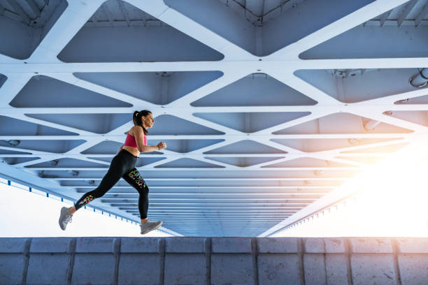 istock Fitness woman running on bridge 1446235365