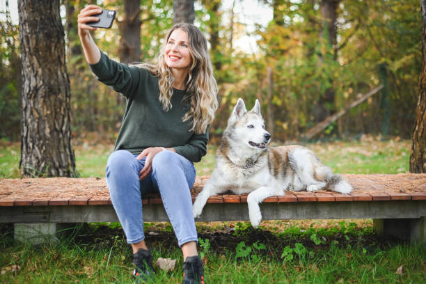 istock beautiful woman walking  with dog (mobile phone) 1446235418