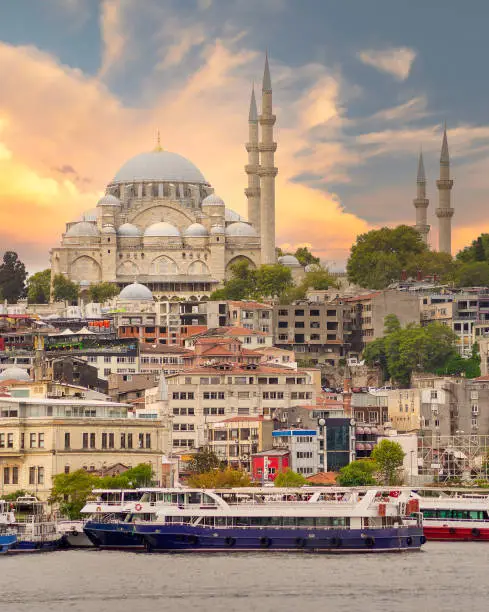 Istanbul city view at Eminonu overlooking the Golden Horn with ferries, ferry terminals, and Suleymaniye Mosque before sunset, Istanbul, Turkey