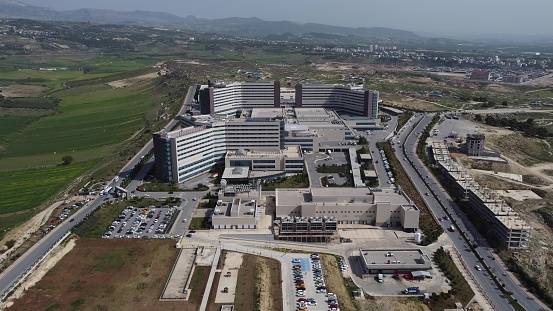 A large hospital complex, vehicles moving around and drone view