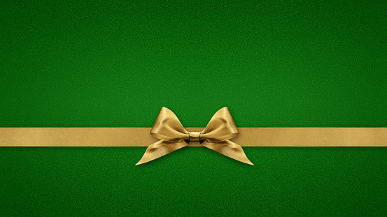 Blank gift greeting card with golden shiny ribbon bow tape, isolated on green background, top view and copy space, template for promotion advertising banner, merry christmas and St. Patrick day