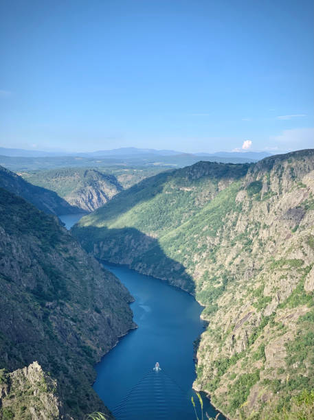 istock River flowing in the valley with boat 1446240488