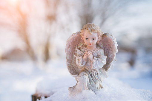 Little Christmas angel toy in the snow