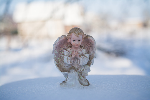 Little Christmas angel toy in the snow