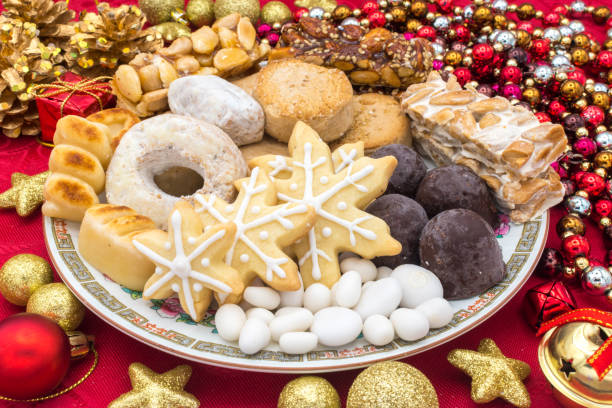 istock Christmas sweets assortment with Chrsitmas decoration on a red tablecloth 1446241998