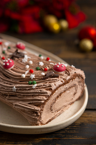 Chocolate log cake, Yule log cake on a Christmas table.