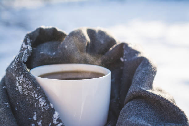 istock White mug with hot coffee in the snow 1446242616