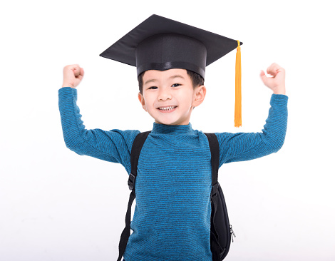 Happy asian child student in a graduate cap