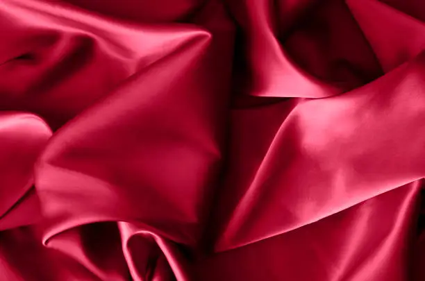 Photo of Fabric background in burgundy color. Color of 2023. Viva. Magenta.