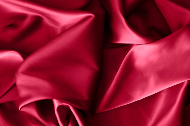fabric background in burgundy color. color of 2023. viva. magenta. - viva magenta stok fotoğraflar ve resimler