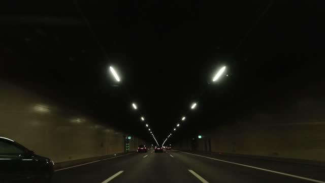 Car point of view on the road while driving in the tunnel