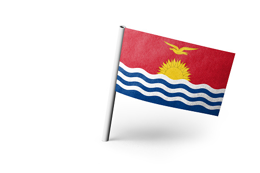 Small paper flag of Kiribati pinned. Isolated on white background. Horizontal orientation. Close up photography. Copy space.