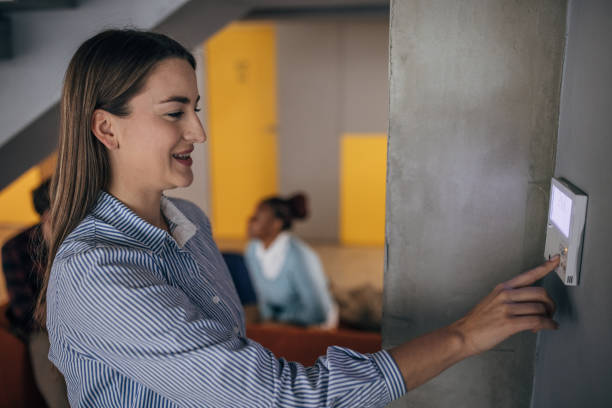 istock Young woman changing temperature on thermometer in the office 1446245665