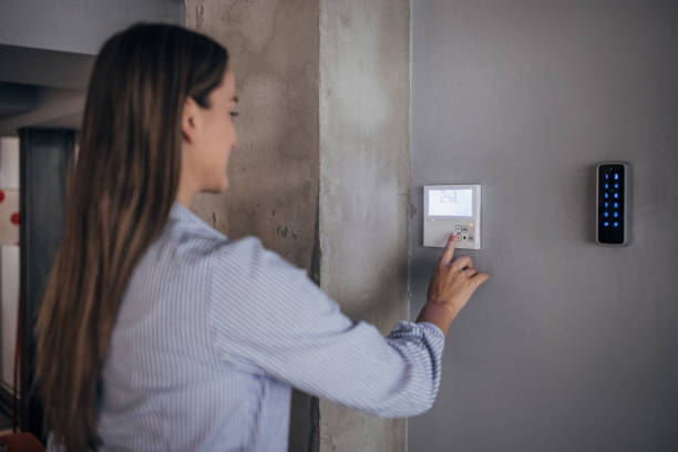 istock Young woman changing temperature on thermometer in the office 1446245741