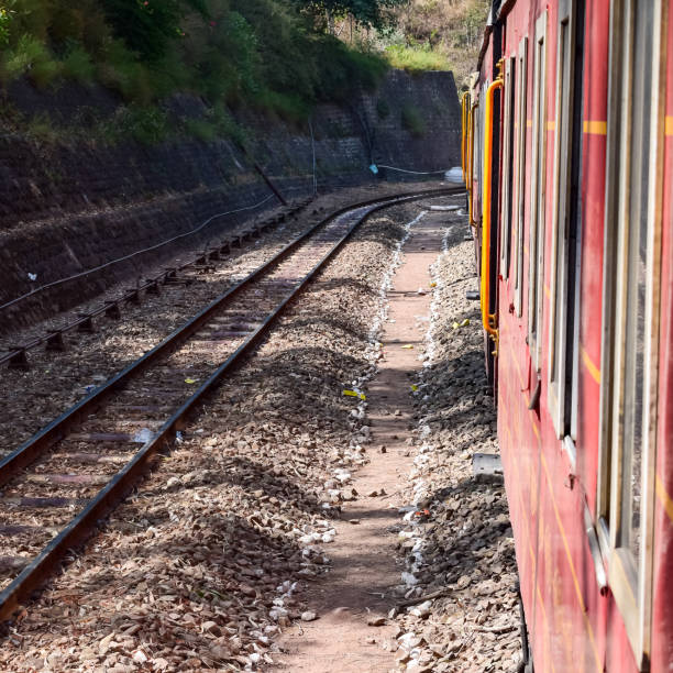 istock Toy Train moving on mountain slopes, beautiful view, one side mountain, one side valley moving on railway to the hill, among green natural forest. Toy train from Kalka to Shimla in India, Indian Train 1446250049