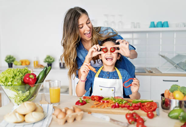 istock Mother and daughter cooking together in a kitchen 1446251696