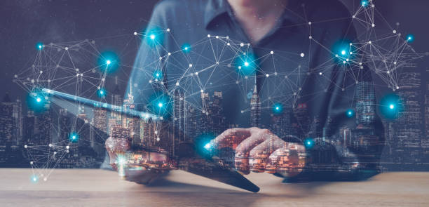 istock businesswoman holding pad tablet with abstract digital business interface on blurry night city background. Technology, finance, success, economy and growth concept. Double exposure. 1446252466