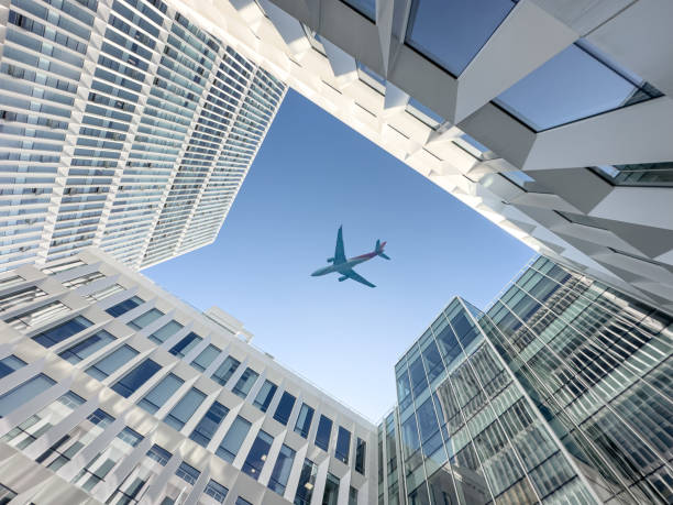 istock Airplane looking up at sky above modern abstract building 1446252932