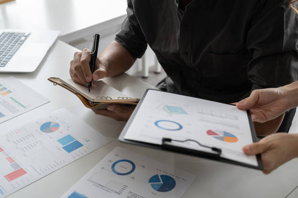 istock Business Colleague Discussing Paperwork Graphs Concept, Close up shot. 1446256343