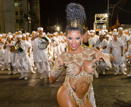 Carnival in Santos city, Brazil. March 3, 2014. Drum queen dancing in front of the musicians. Parade of the Amazonense samba school.