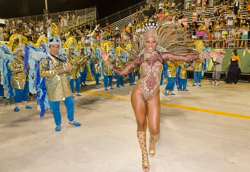 Carnival in Santos city, Brazil. March 3, 2014. Drum queen dancing in front of the musicians. Parade of the Vila Mathias samba school.