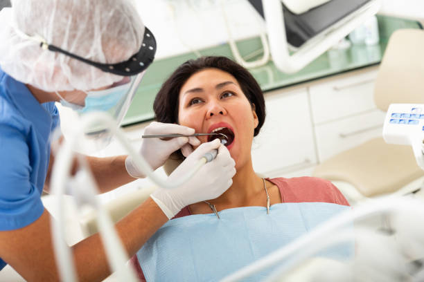 istock Dentist drilling tooth to asian female patient 1446258568