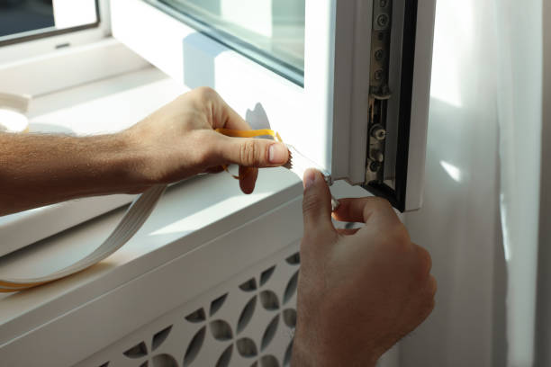 istock Man putting rubber draught strip onto window, closeup 1446262199