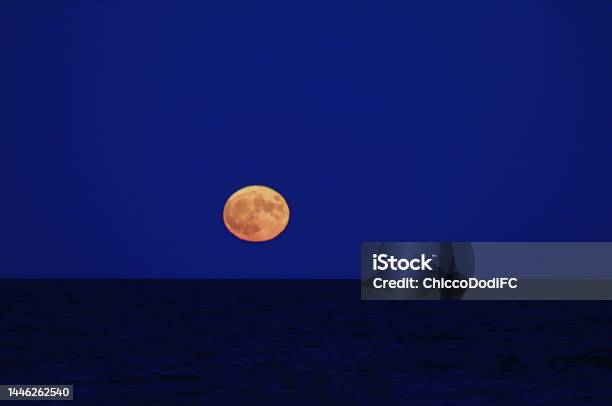 Red Full Moon Over The Calm Sea Stock Photo - Download Image Now - Astrology, Astronomy, Circle