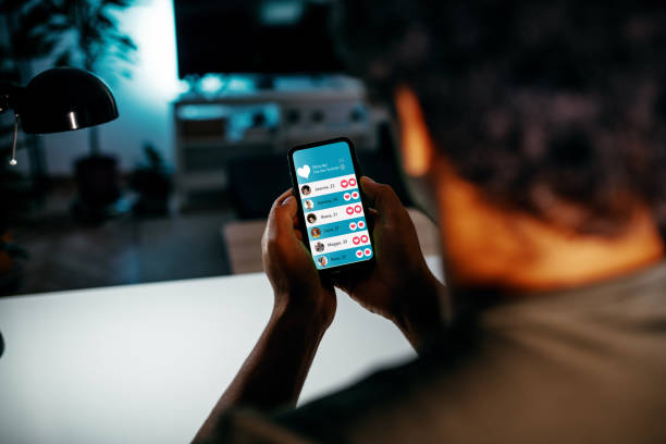 Unrecognisable an using dating app on smart phone. Man looking for date on mobile app