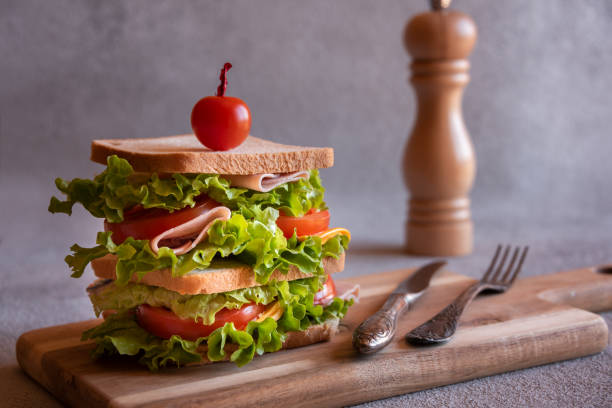 istock Homemade sandwich with cheese, ham, tomatoes and vegetables 1446267293