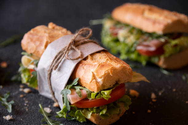 istock Baguette sandwich with cheese, ham, tomatoes and vegetables 1446269151