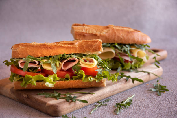 istock Baguette sandwich with cheese, ham, tomatoes and vegetables 1446269277