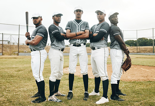 Baseball, team and sports with a man athlete group standing together on a field or grass pitch together. Teamwork, uniform and sport with a male player and friends ready for a game or match outdoor