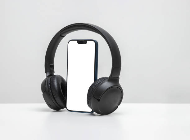istock Smartphone with bluetooth headphones with white screen 1446269786