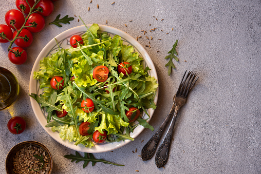 Fresh vegetables salad with tomatoes, arugola, lettuce and other ingredients, healthy food
