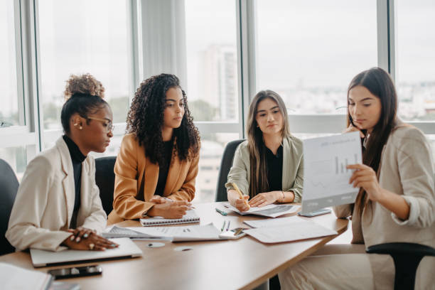 istock analyzing report in business meeting between women 1446273558