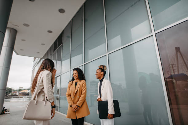 istock women talking in front of their work building 1446274088