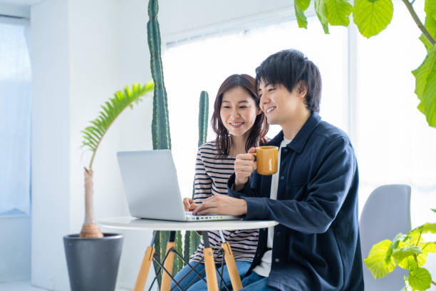 istock A couple surfing the internet on a computer in a bright living room 1446277403