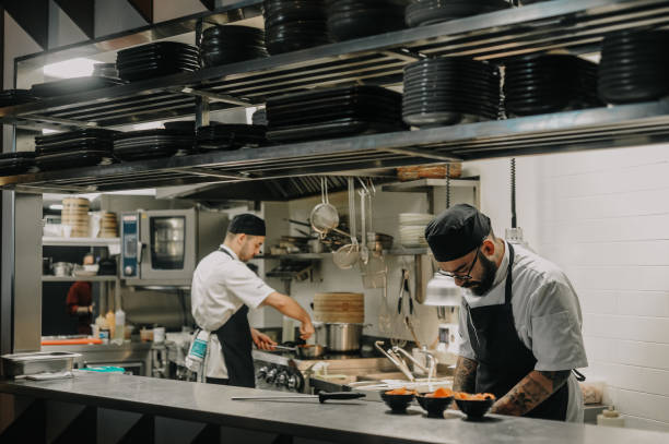 Chef working in a high end restaurant kitchen stock photo