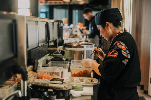 istock Thai female chef preparing food in restaurant kitchen 1446277892