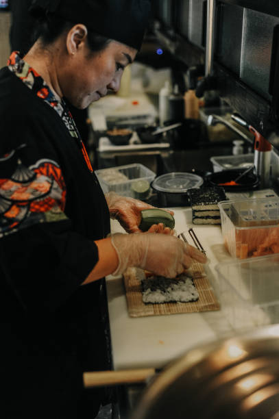 istock Thai female chef preparing food in restaurant kitchen 1446277950