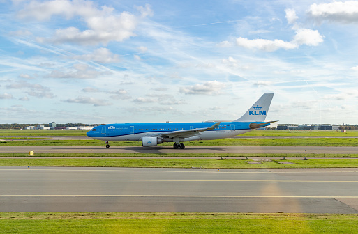 Iceland Air Plane Wing  with KLM Boeing in background, Schipol Airport, Amsterdam, Netherlands - 22 June 2022 : The Iceland Air plane wing can be seen against the backdrop of a KLM Boeing plane ready for take off at Schipol Airport, the main International airport in The Netherlands