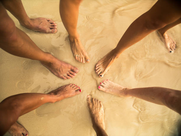 istock group of people comparing feet at the beach 1446280352