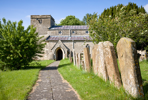 Exterior of old church with graveyard, St John the Baptist Church in Preston Bissett, Buckinghamshire, UK