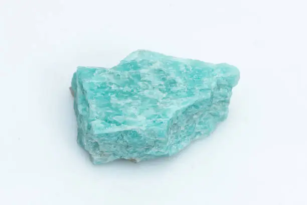 Natural amazonite gemstone isolated on white background. A bluish-green crystal on a background. A variety of potassium feldspar microcline