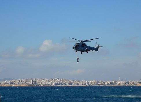 November 5th, 2022, Faliro, Athens, Greece. A Eurocopter AS232 Super Puma, Search and Rescue (SAR) helicopter, of the Hellenic Air Force, performing a rescue at sea, during an airshow