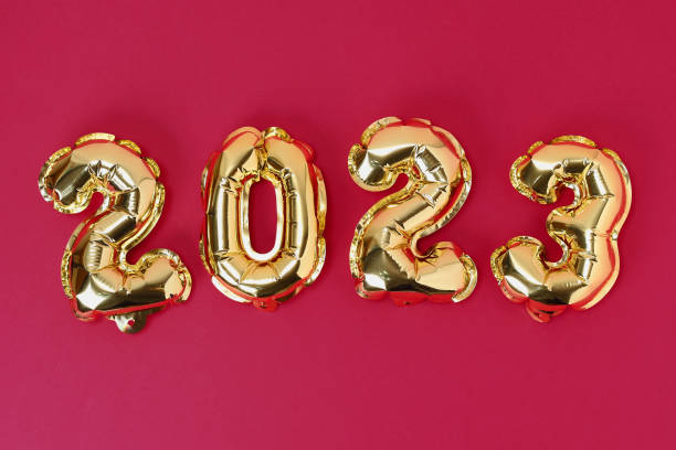 viva magenta color of the year 2023. new year 2023. foil balloons numbers 2023 on red background. new year christmas. - viva magenta stok fotoğraflar ve resimler