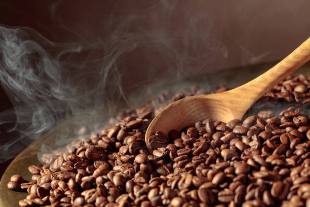 istock Coffee beans are smoky in a roasting pan. 1446288930